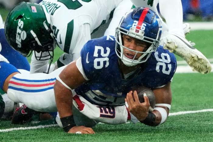 Barkley (26) is shown with the ball against the Jets. The Giants' star running back is on the verge of hitting free agency and there is plenty of debate over his uncertain future with Big Blue.